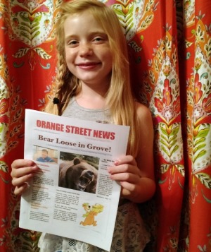 Journalist Hilde Kate Lysiak shows off her newspaper, the Orange Street News.