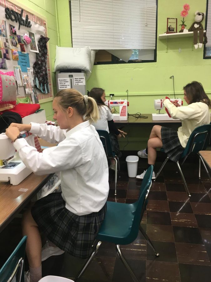 Mrs. Tabbert’s  3rd period sewing class threading their machines.