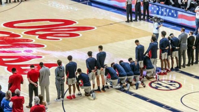 8 Ole Miss players take a knee during a conference game on February 23rd 