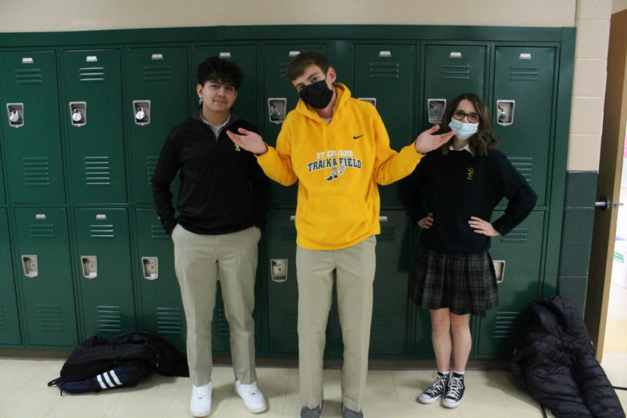 Robert Avina (left) and Nina Filippi (right) show off their uniforms while Michael Cozzi (center) forgets spirit wear is no longer allowed.