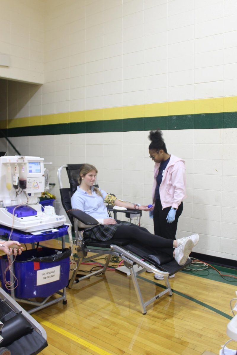 Erica Scheider, '27, donates during NHS's December blood drive. 